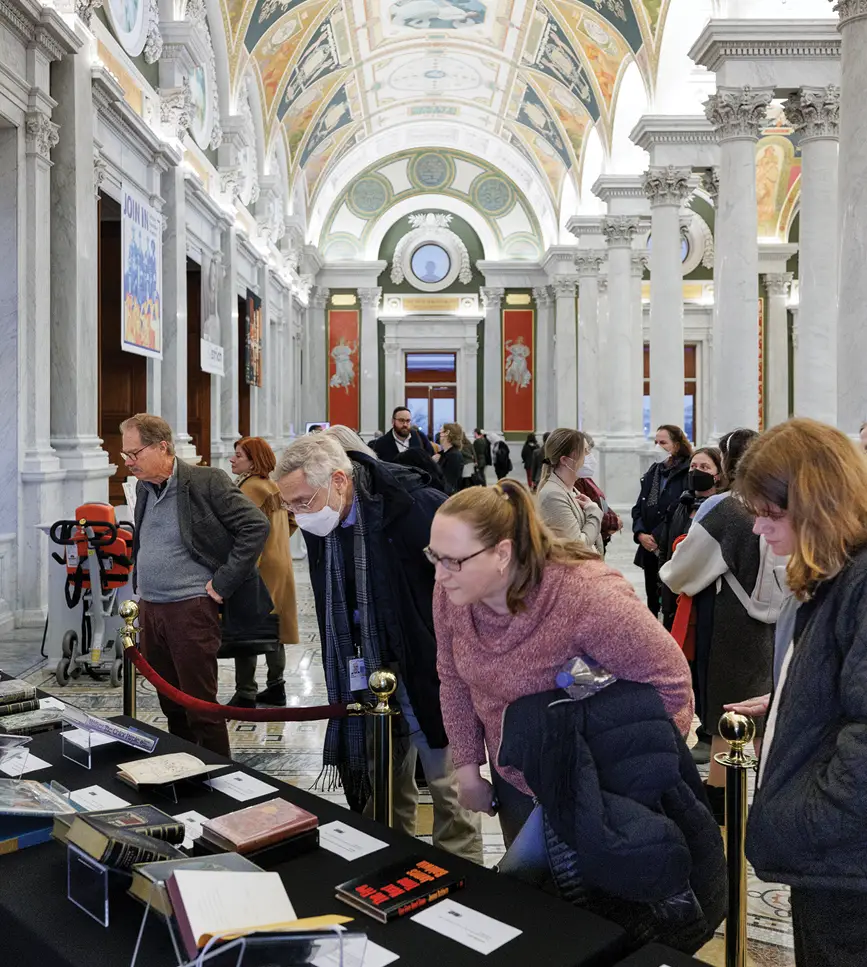 Visitors examine holdings from the Library’s Aramont collection of first editions, exhibition bindings and illustrated books on Jan. 19 in the Great Hall.